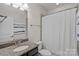 Neutral bathroom features a dark vanity with granite counters and a tub/shower combination at 4311 Sheffield Park Ave, Charlotte, NC 28211