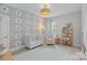 Charming Bedroom with patterned wallpaper, comfortable armchair, and plenty of natural light at 4311 Sheffield Park Ave, Charlotte, NC 28211