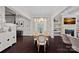 Elegant dining room with hardwood floors, chandelier, and views into the living area with fireplace at 4311 Sheffield Park Ave, Charlotte, NC 28211