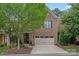 Charming brick home features a two-car garage and well-manicured landscaping, creating great curb appeal at 4311 Sheffield Park Ave, Charlotte, NC 28211