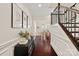 Inviting foyer featuring hardwood floors, decorative molding, and staircase with wrought iron railings at 4311 Sheffield Park Ave, Charlotte, NC 28211