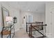 Upstairs hallway featuring lovely natural light, decorative alcove, and railing at 4311 Sheffield Park Ave, Charlotte, NC 28211