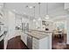 Open kitchen with stainless steel appliances, granite counters, and seamless flow into the dining area at 4311 Sheffield Park Ave, Charlotte, NC 28211