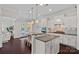 Bright kitchen showcases white cabinets, a center island, stainless appliances, and access to the patio at 4311 Sheffield Park Ave, Charlotte, NC 28211