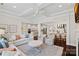 Open-concept living room with coffered ceilings seamlessly connects to the kitchen and dining area at 4311 Sheffield Park Ave, Charlotte, NC 28211