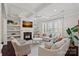 Bright living room with coffered ceilings, built-in shelves, and a cozy fireplace at 4311 Sheffield Park Ave, Charlotte, NC 28211