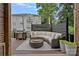 Inviting patio features a large outdoor couch, BBQ grill and string lights for cozy entertaining at 4311 Sheffield Park Ave, Charlotte, NC 28211