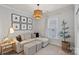 Cozy sitting area features modern lighting, neutral tones, and a window bringing in natural light at 4311 Sheffield Park Ave, Charlotte, NC 28211