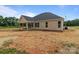 Backyard featuring new home with tan siding, dark roof, covered patio, and windows at 4949 Rimer Rd # 4, Concord, NC 28025