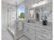 Elegant bathroom featuring a glass-enclosed shower, marble walls, double vanity, and ample natural light from the window at 4949 Rimer Rd # 4, Concord, NC 28025
