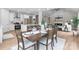 A dining room features a wooden table set for six, complemented by modern lighting and an open view to the kitchen at 4949 Rimer Rd # 4, Concord, NC 28025