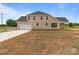 Newly built house with an attached two-car garage, dark roof, and yard at 4949 Rimer Rd # 4, Concord, NC 28025