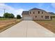 Spacious home exterior featuring an attached garage and long concrete driveway at 4949 Rimer Rd # 4, Concord, NC 28025
