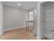 Upstairs hallway with wood floors, banister, and a hall linen closet at 4949 Rimer Rd # 4, Concord, NC 28025