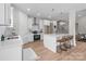 Bright kitchen features white cabinets, stainless appliances, quartz countertops, and a central island with bar stool seating at 4949 Rimer Rd # 4, Concord, NC 28025