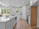 Open kitchen features an island with quartz countertops, stainless appliances, and plenty of cabinet space at 4949 Rimer Rd # 4, Concord, NC 28025