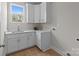 Convenient laundry room with white cabinets and countertop space at 4949 Rimer Rd # 4, Concord, NC 28025