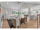 An open-concept living area is bright and inviting, with views of the dining area, kitchen and hardwood floors at 4949 Rimer Rd # 4, Concord, NC 28025