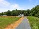 Aerial view showcases the home's location, surrounded by trees and fields at 4975 Rimer Rd # 1, Concord, NC 28025