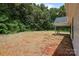 Spacious backyard features lush trees, a covered patio, and level ground at 4975 Rimer Rd # 1, Concord, NC 28025