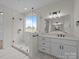 Bathroom featuring a glass shower with a window, a vanity and white tile floors at 4975 Rimer Rd # 1, Concord, NC 28025