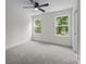 Bedroom with a ceiling fan, carpet floors and a dual window providing ample light at 4975 Rimer Rd # 1, Concord, NC 28025