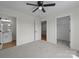 Bedroom featuring neutral carpet with several doors offering access to bathroom, closet, and hallway at 4975 Rimer Rd # 1, Concord, NC 28025