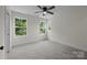 Bright bedroom featuring neutral walls and carpet with multiple windows offering scenic views at 4975 Rimer Rd # 1, Concord, NC 28025