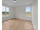 Bright bedroom features beautiful floors, two windows, and neutral paint at 4975 Rimer Rd # 1, Concord, NC 28025