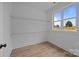 Walk-in closet featuring wood-look floors, shelving, and a bright window at 4975 Rimer Rd # 1, Concord, NC 28025