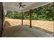 Outdoor covered patio with wood pillars and a ceiling fan overlooking a spacious backyard at 4975 Rimer Rd # 1, Concord, NC 28025