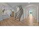 Open-concept home showcasing kitchen, wooden staircase, and arched doorway at 4975 Rimer Rd # 1, Concord, NC 28025