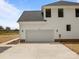 View of the home's white garage door, matching siding, and well-paved driveway at 4975 Rimer Rd # 1, Concord, NC 28025