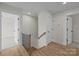 Hallway with wood floors, white trim, and stairs leading to other floors at 4975 Rimer Rd # 1, Concord, NC 28025