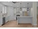 Spacious white kitchen featuring an island with quartz countertop and stainless steel appliances at 4975 Rimer Rd # 1, Concord, NC 28025