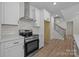 Modern kitchen features stainless steel appliances, white cabinets, and hardwood floors at 4975 Rimer Rd # 1, Concord, NC 28025