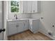 Laundry room features cabinets, a sink and hardwood floors at 4975 Rimer Rd # 1, Concord, NC 28025