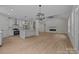 Open floor plan with a living room featuring a vaulted ceiling, modern fireplace and light, wood-look floors at 4975 Rimer Rd # 1, Concord, NC 28025