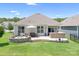 Charming backyard with a stone patio, fire pit, built-in grill, and lush green lawn at 5058 Antebellum Dr, Iron Station, NC 28080