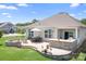 Charming backyard with a stone patio, fire pit, built-in grill, and lush green lawn at 5058 Antebellum Dr, Iron Station, NC 28080