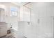 Bathroom featuring a glass shower, tub, and granite countertop at 5058 Antebellum Dr, Iron Station, NC 28080