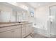 Bright bathroom with double vanity, a soaking tub, and a separate glass shower at 5058 Antebellum Dr, Iron Station, NC 28080
