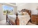 Bedroom with large window, wood bed frame, floral bedding and trim package at 5058 Antebellum Dr, Iron Station, NC 28080