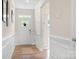 Bright foyer with hardwood floors, paneled walls, and a view of the front door at 5058 Antebellum Dr, Iron Station, NC 28080