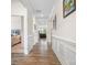 Spacious hallway featuring hardwood floors, decorative moldings, and views into adjacent living spaces at 5058 Antebellum Dr, Iron Station, NC 28080