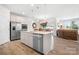 Modern kitchen with stainless steel appliances, a center island, and an open layout connected to the living area at 5058 Antebellum Dr, Iron Station, NC 28080