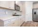 Bright kitchen with white cabinets, stainless steel appliances, and sleek countertops at 5058 Antebellum Dr, Iron Station, NC 28080