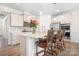 Stylish kitchen featuring a center island with seating, stainless steel appliances, and elegant pendant lighting at 5058 Antebellum Dr, Iron Station, NC 28080