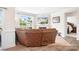 Comfortable living room with leather sectional, fireplace, large window with views and wood floors at 5058 Antebellum Dr, Iron Station, NC 28080