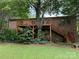 Back exterior view of brick home featuring a wooden deck with stairs and a well-manicured lawn at 5198 Wright Dr, Hickory, NC 28602